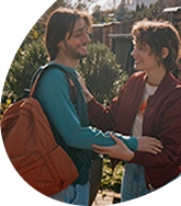 Man smiling greeting woman embracing him and smiling
